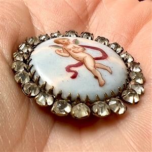 A 19th c. Transfer on porcelain button of cherub.