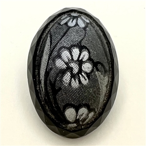 Oval imitation fabric black glass button.