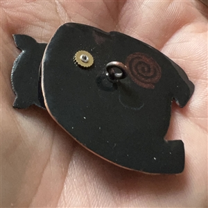 Janet White’s “Black Bear with Supper” enamel on copper studio button.