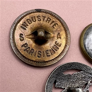 Three metal buttons of butterflies.