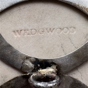 Extra large Wedgwood button of a cherub with a wreath.
