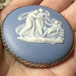 Extra large Wedgwood of cupid interacting with a couple button.