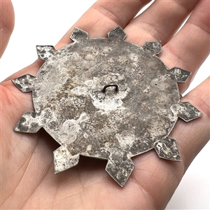Huge chased and silvered metal button of the “Eye of Providence.”