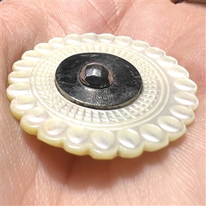 An 18th c. Carved pearl with steel button.