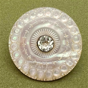 An 18th c. carved mother of pearl button with faceted paste center.