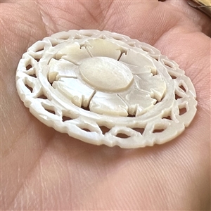 Bethlehem pearl button of a target design.