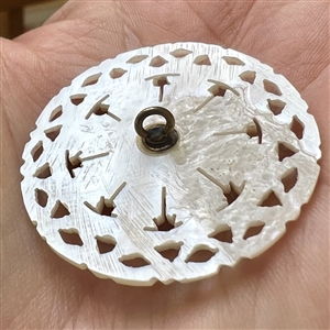 Bethlehem pearl button of a target design.
