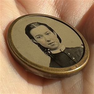 Tintype button of a young woman.