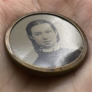 Tintype button of a young woman.
