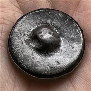 Tintype button of a young woman.