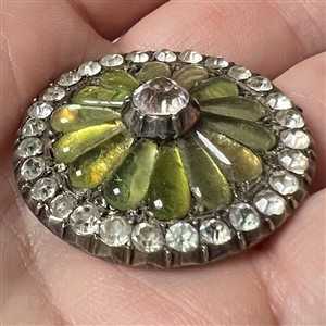 A 19th c. iridescent glass set in metal button with faceted pastes.