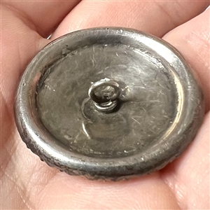 A 19th c. iridescent glass set in metal button with faceted pastes.