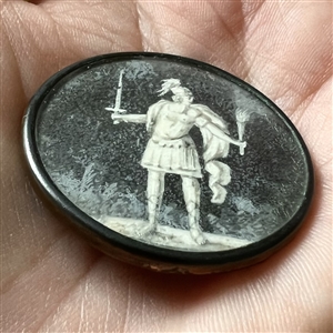 An 18th c. painting on natural material under glass set in metal button of warrior.