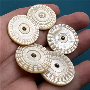 Five thick Colonial pearl buttons.