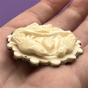 Lovebirds, carved natural material prong set in silver button. 