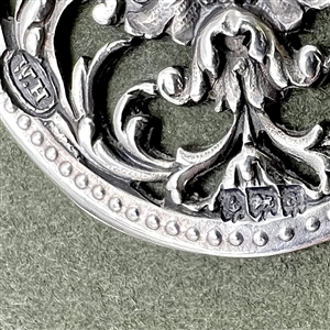 Hallmarked silver button of greenman.