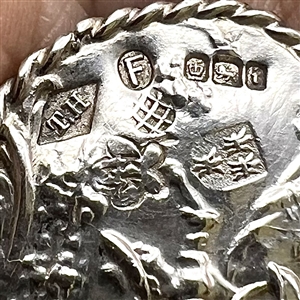 Hallmarked silver button of a girl picking fruit.