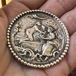Large Continental silver button of a man courting a woman.