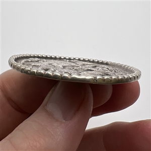 Large Continental silver button of a man courting a woman.