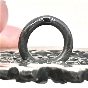 Silver button imitating “Court Steel.”