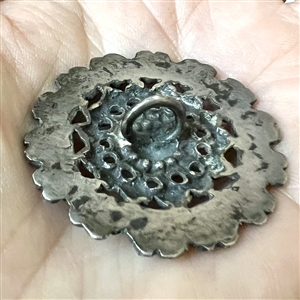 Silver button imitating “Court Steel.”