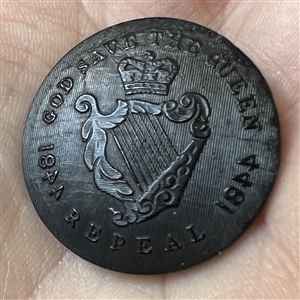 Two buttons of molded horn. The verbal is an Irish Repeal button from the mid 1800s.