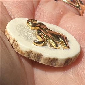 Yellow metal elephants on antler button.
