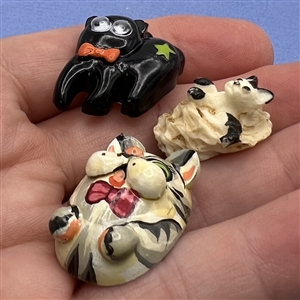Three cute buttons of cats.