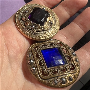 Two Gay 90’s jeweled buttons.