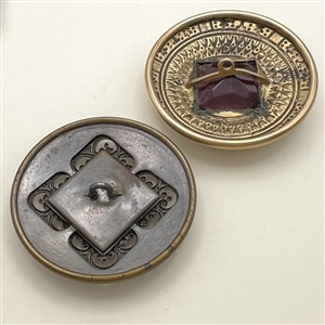 Two Gay 90’s jeweled buttons.