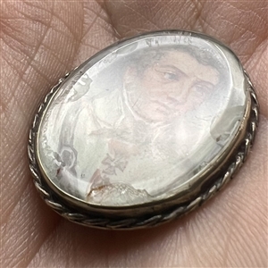 An 19th c. painting under glass of a man set in unmarked silver button.