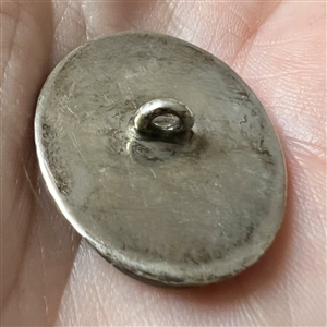 An 19th c. painting under glass of a man set in unmarked silver button.