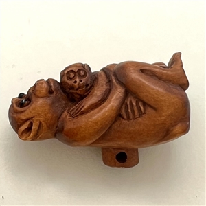Boxwood button of mother and baby monkey. 