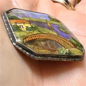 Reverse painted lake scene with bridge and sail boat with real butterfly wing background button.