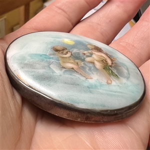 Extra large porcelain button of cherubs.