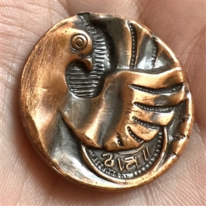 Stamped copper button of “time flies.”