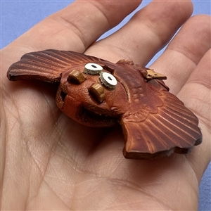 Owl with mouse in talons leather button.