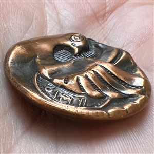 Stamped copper button of “time flies.”