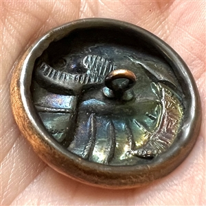 Stamped copper button of “time flies.”