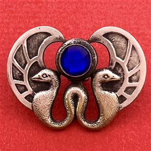 Silvered brass button of two birds and cobalt glass “jewel.”