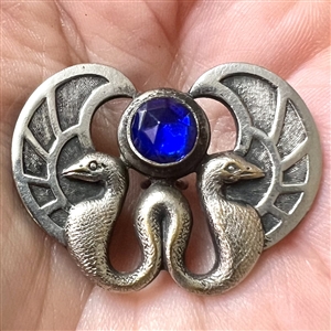 Silvered brass button of two birds and cobalt glass “jewel.”