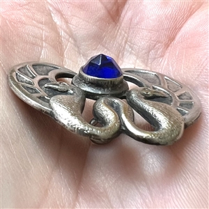 Silvered brass button of two birds and cobalt glass “jewel.”