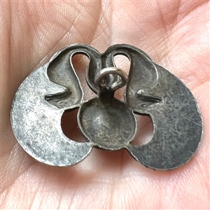 Silvered brass button of two birds and cobalt glass “jewel.”