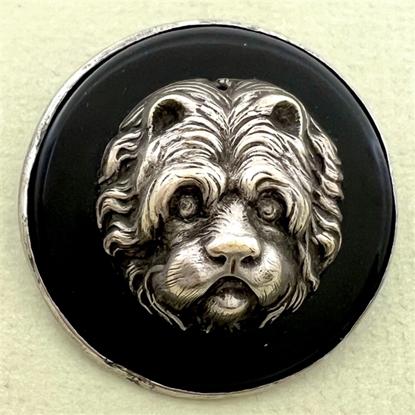 Large sculptural white metal escutcheon of a dog over plastic button.
