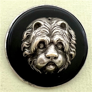 Large sculptural white metal escutcheon of a dog over plastic button.