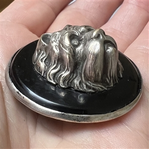 Large sculptural white metal escutcheon of a dog over plastic button.