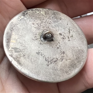Large sculptural white metal escutcheon of a dog over plastic button.