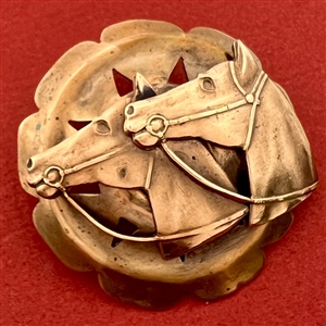 Brass button with two horse heads escutcheon.