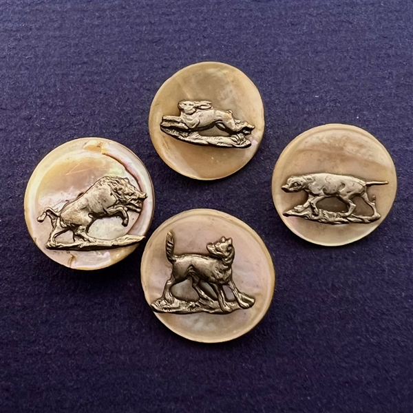 Four shell sporting buttons with escutcheons.