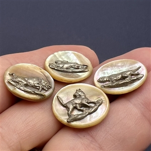 Four shell sporting buttons with escutcheons.